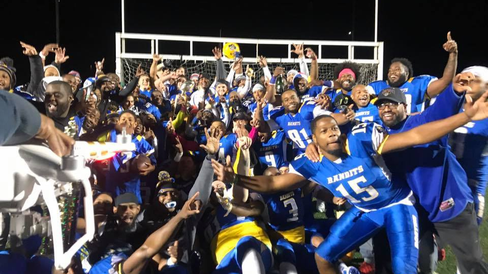 NEFL champions hoisting championship trophy